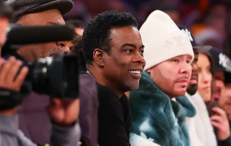 NEW YORK, NEW YORK - DECEMBER 25: Comedian and actor Chris Rock sits on celebrity row during the third quarter of the game at Madison Square Garden on December 25, 2023 in New York City. NOTE TO USER: User expressly acknowledges and agrees that, by downloading and or using this photograph, User is consenting to the terms and conditions of the Getty Images License Agreement.   Rich Graessle/Getty Images/AFP (Photo by Rich Graessle / GETTY IMAGES NORTH AMERICA / Getty Images via AFP)