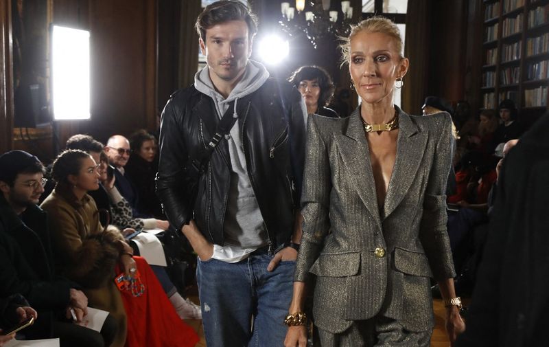 Canadian singer Celine Dion (R) and Spanish dancer Pepe Munoz (L) arrive for the 2019 Spring-Summer Haute Couture collection fashion show by RVDK Ronald van der Kemp in Paris, on January 23, 2019. (Photo by FRANCOIS GUILLOT / AFP)
