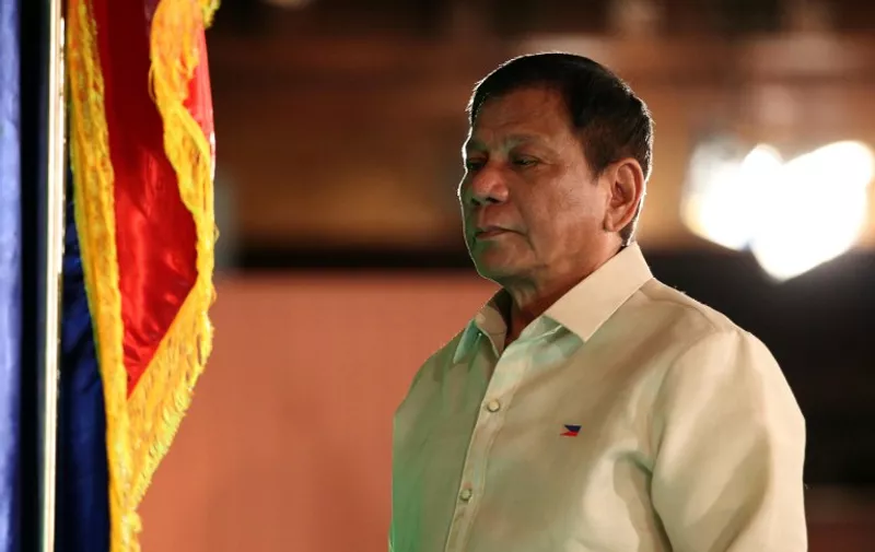 In this handout photo taken on June 30, 2016 and released by the Presidential Communication Operations Office (PCOO) Phillippine President Rodrigo Duterte stands during the swearing in ceremony at the Malacanang Palace in Manila.
Authoritarian firebrand Rodrigo Duterte was sworn in as the Philippines' president on June 30, after promising a ruthless and deeply controversial war on crime would be the main focus of his six-year term.   / AFP PHOTO / PCOO / HO / --- EDITORS NOTE RESTRICTED TO EDITORIAL USE - MANDATORY CREDIT "AFP PHOTO / PRESIDENTIAL COMMUNICATION OPERATIONS OFFICE"- NO MARKETING NO ADVERTISING CAMPAIGNS - DISTRIBUTED AS A SERVICE TO CLIENTS ---