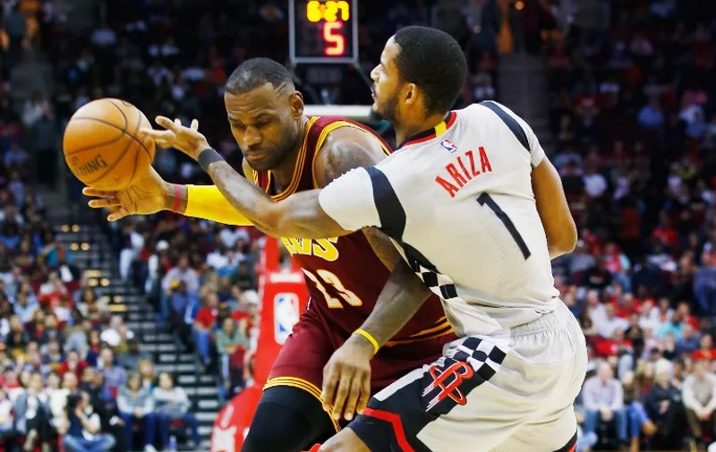 HOUSTON, TX - JANUARY 15: LeBron James #23 of the Cleveland Cavaliers drives with the ball against Trevor Ariza #1 of the Houston Rockets during their game at the Toyota Center on January 15, 2016 in Houston, Texas. NOTE TO USER: User expressly acknowledges and agrees that, by downloading and or using this Photograph, user is consenting to the terms and conditions of the Getty Images License Agreement.   Scott Halleran/Getty Images/AFP