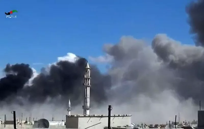 An image grab taken from a video released by the Homs Media Center on September 30, 2015 shows smoke billowing from buildings and a minaret in the central Syrian town of Talbisseh in Homs province. Russian warplanes carried out air strikes in three Syrian provinces, including Homs, along with regime aircraft on September 30, according to a Syrian security source. Earlier in the day, the Syrian Observatory for Human Rights, a Britain-based monitor, reported at least 27 civilians had been killed in air strikes in the Homs province, adding that the strikes hit Rastan, Talbisseh and Zaafarani. The other Syrian security source said the Russian strikes had hit Rastan and Talbisseh in the province of Homs.  AFP PHOTO / Homs Media Center
=== RESTRICTED TO EDITORIAL USE - MANDATORY CREDIT "AFP PHOTO / Homs Media Center" - NO MARKETING NO ADVERTISING CAMPAIGNS - DISTRIBUTED AS A SERVICE TO CLIENTS ===