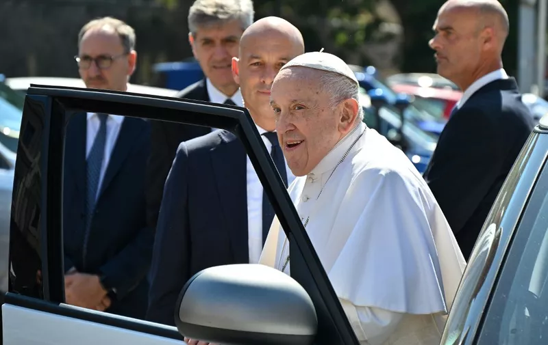 Pope Francis exits his car while arriving at The Vatican's Porta del Perugino gate on June 16, 2023 after being discharged from the Gemelli hospital in Rome, where he underwent abdominal surgery last week. (Photo by Filippo MONTEFORTE / AFP)
