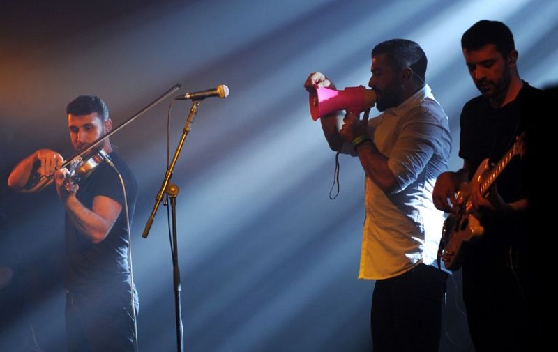 (From L) Haig Papazian, Hamed Sinno (R) and Ibrahim Badr of Lebanese alternative rock band Mashrou' Leila perform on stage at the 39th "Le Printemps de Bourges" rock and pop music festival in Bourges, central France, on April 26, 2015. AFP PHOTO / GUILLAUME SOUVANT / AFP PHOTO / GUILLAUME SOUVANT