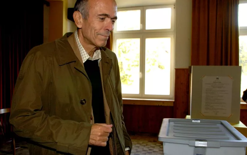 Slovenian President Janez Drnovsek smiles after casting his ballot during the presidential elections at a polling station in Zaplana 21 October 2007. Drnovsek, a former Communist technocrat who decided not to be a candidate for second term and who oversaw his country's successful transition to a market economy and its entry into the European Union, has created tensions with the government with his new spiritual lifestyle and independent policies. The 56-year-old bachelor, who bakes his own bread and has appeared in public more than once with a drooping crown of leaves on his head, was prime minister from 1992 to 2002 before being elected president in December 2002. But after he was diagnosed with lung and liver cancer two years ago, the former banker with a PhD in economics decided on a radical change in lifestyle, reinventing himself as a type of guru who sees an apocalypse and the death of millions of people as the only way to "awake" humanity. Slovenia's 1.7 million voters are taking part in their third presidential election since the country gained independence from Yugoslavia in 1991. The new president will head the tiny alpine state when it takes over the revolving six-month presidency of the European Union in January 2008. According to the final opinion polls, none of the seven candidates is expected to gain the absolute majority needed to win the first round and a runoff 11 November 2007 is virtually certain.   AFP PHOTO/ Stringer
