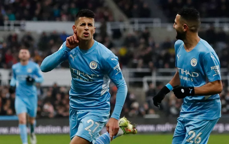 Soccer Football - Premier League - Newcastle United v Manchester City - St James' Park, Newcastle, Britain - December 19, 2021 
Manchester City's Joao Cancelo celebrates scoring their second goal with Riyad Mahrez Action Images via Reuters/Lee Smith EDITORIAL USE ONLY. No use with unauthorized audio, video, data, fixture lists, club/league logos or 'live' services. Online in-match use limited to 75 images, no video emulation. No use in betting, games or single club	/league/player publications.  Please contact your account representative for further details.