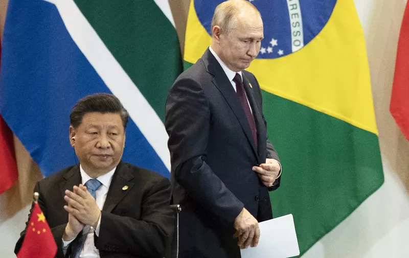 China's President Xi Jinping (L) and Russia's President Vladimir Putin attend attend a meeting with members of the Business Council and management of the New Development Bank during the BRICS Summit in Brasilia, November 14, 2019. (Photo by Pavel Golovkin / POOL / AFP)