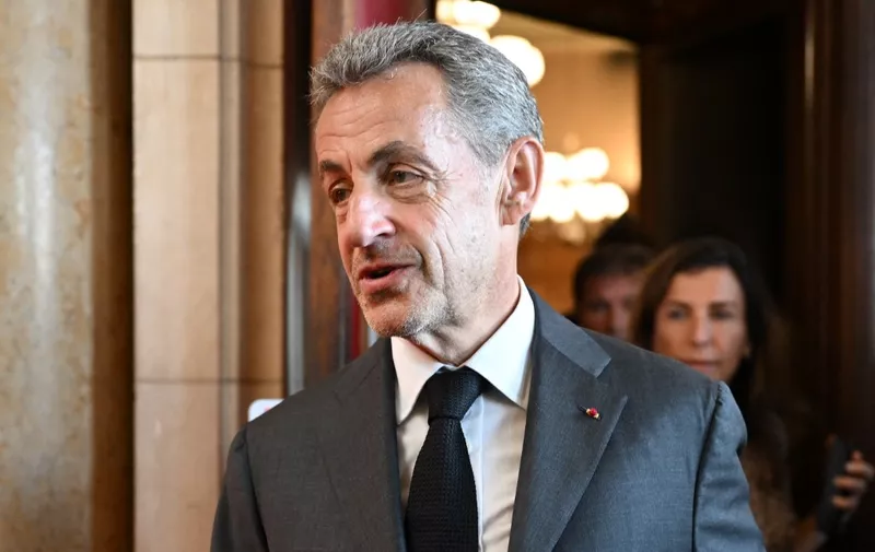 Former French President Nicolas Sarkozy leaves the courthouse after the ruling in his appeal trial in a corruption case at Paris courthouse on May 17, 2023. A French court of appeals on May 17, 2023 upheld a prison sentence of three years, including two suspended, against former president Nicolas Sarkozy for corruption and influence peddling. (Photo by bERTRAND GUAY / AFP)