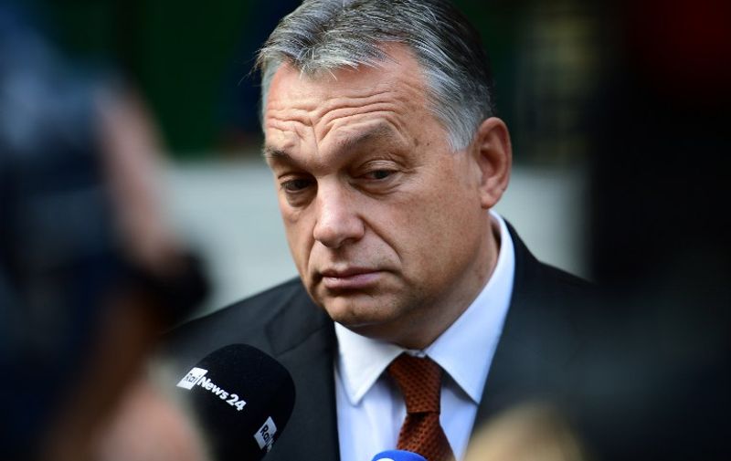 Hungarian Prime Minister Viktor Orban reacts as he answers to the journalists in front of a polling station at a school in Budapest, on October 2, 2016. 
Hungarians vote in a referendum on taking migrants as part of an EU-wide mandatory quota scheme, a plan rejected by right-wing Prime Minister Viktor Orban. / AFP PHOTO / ATTILA KISBENEDEK