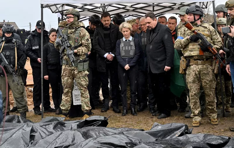 Slovakia's Prime Minister Eduard Heger (C-L) stands next to European Commission President Ursula von der Leyen, and European Union High Representative for Foreign Affairs and Security Policy Josep Borrell as they visit a mass grave in the town of Bucha, northwest of Kyiv on April 8, 2022. (Photo by Sergei SUPINSKY / AFP)