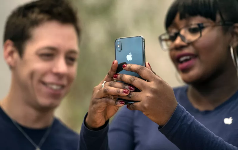 LONDON, ENGLAND - NOVEMBER 03: Staff members view the new iPhone X in the Apple store upon its release in the U.K, on November 3, 2017 in London, England. The iPhone X is positioned as a high-end, model intended to showcase advanced technologies such as wireless charging, OLED display, dual cameras and a face recognition unlock system.  (Photo by Carl Court/Getty Images)
