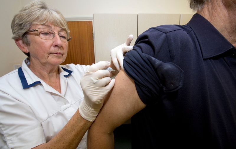 MODEL RELEASED. Nurse injecting flu (influenza) vaccine into the arm of an elderly male patient in order to vaccinate him against future flu virus infection.,Image: 170589879, License: Rights-managed, Restrictions: , Model Release: yes