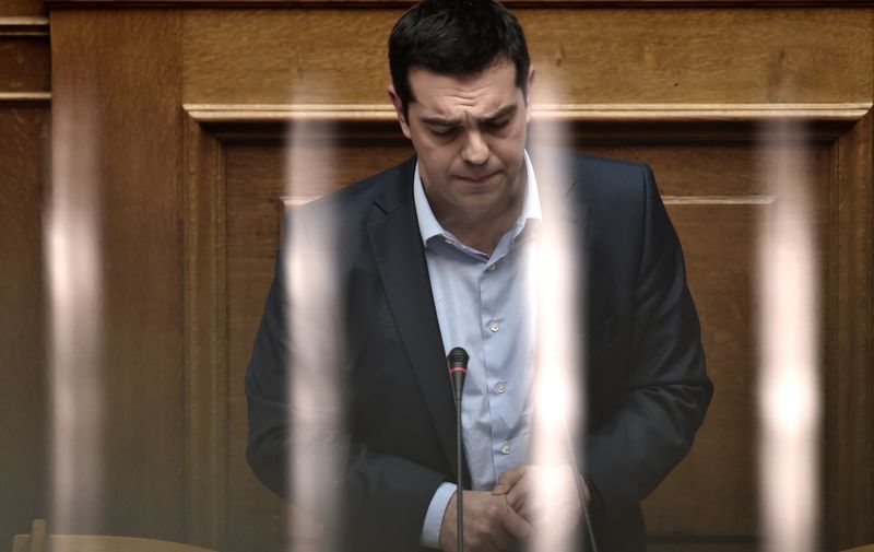 Greek Prime Minister Alexis Tsipras addresses a parliament session in Athens on March 30, 2015. The EU warned Monday that Greece and its creditors had yet to hammer out a new list of reforms despite talks lasting all weekend aimed at staving off bankruptcy and a euro exit. AFP PHOTO / ARIS MESSINIS