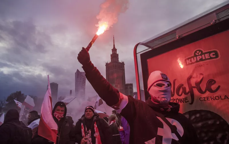 November 11, 2017 - Mazovia, Poland - Member of a far right group holds a flare in the streets of Warsaw celebrating the Independence Day of Poland.  On Saturday, 11 November 2017, in Warsaw, Poland., Image: 355151365, License: Rights-managed, Restrictions: * France Rights OUT *, Model Release: no, Credit line: Profimedia, Zuma Press - News