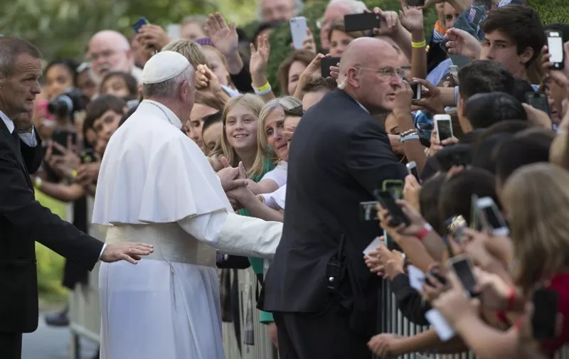 Security work the crowd as Pope Francis greets well-wishers as he leaves the Apostolic Nunciature to the United States  on September 24, 2015 in Washington, DC.  AFP PHOTO/MOLLY RILEY
