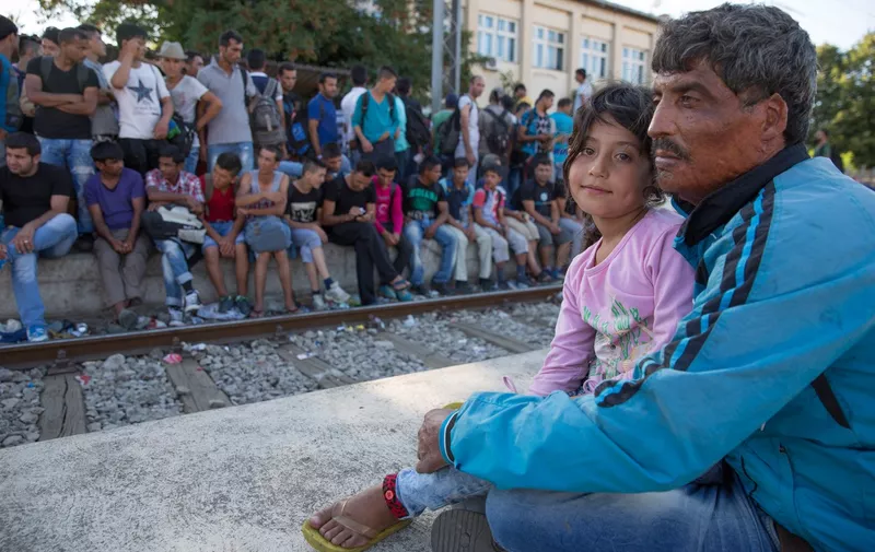 Gevgelija, Macedonia. 18th August 2015 -- A Syrian father from Aleppo waits together with his daughter to catch a train in Gevgelija, on the Macedonian-Greek border, to desperately continue the family journey to Belgrade in Serbia. The mother of the girl died during the war. -- Hundreds of desperate refugees wait at the Gevgelija railway station on the Macedonian-Greek border before jamming themselves onto trains in order to continue their journey to Belgrade in Serbia and other European countries., Image: 255987579, License: Rights-managed, Restrictions: Copyright by creator, licensed through Demotix Ltd. Please see license for more details. Demotix Wire Subscriptions images have a 48 hour licence, after which revert to per image pricing. Contact us for details., Model Release: no, Credit line: Profimedia, Demotix