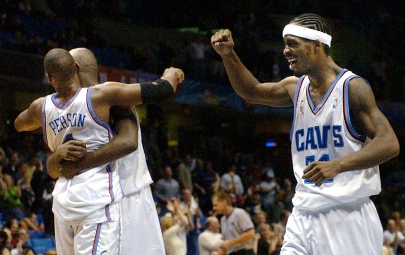 Cleveland Cavaliers Players Wesley Person (L) and Lamond Murray (C) embrace as teammate Ricky Davis (R) begins to celebrate as the overtime period ends on 24 November, 2001 at Gund Arena in Cleveland, OH.   Cleveland defeated Miami 100-96 in overtime.  AFP PHOTO DAVID MAXWELL
 / AFP / DAVID MAXWELL