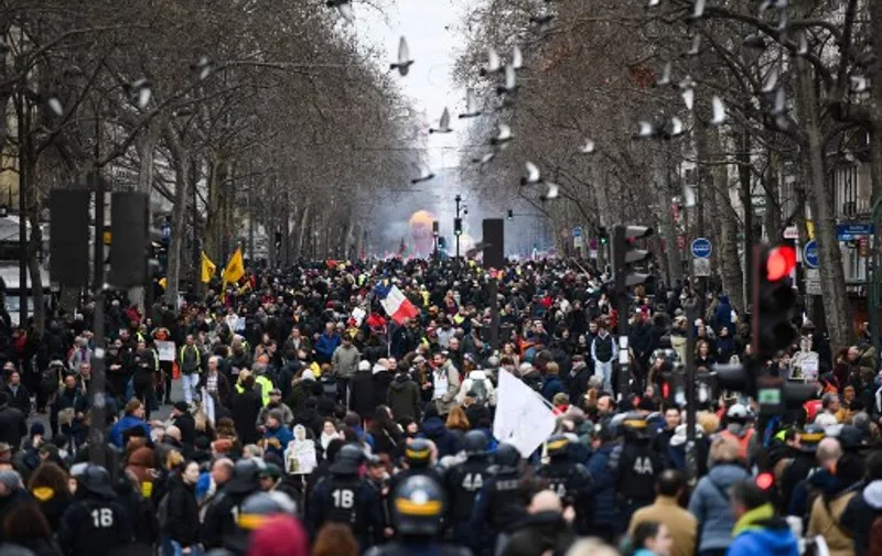 Protestors march at Place de la Bastille during a demonstration, as part of a nationwide day of strikes and protests called by unions over the proposed pensions overhaul, in Paris on March 11, 2023. - The reform proposed by the government includes the raise of the minimum retirement age from 62 to 64 years and the increase of the number of years people have to make contributions for a full pension. Unions have vowed to keep up the pressure on the government, with a seventh day of mass protests, and some have even said they would keep up rolling indefinite strikes. (Photo by Christophe ARCHAMBAULT / AFP)