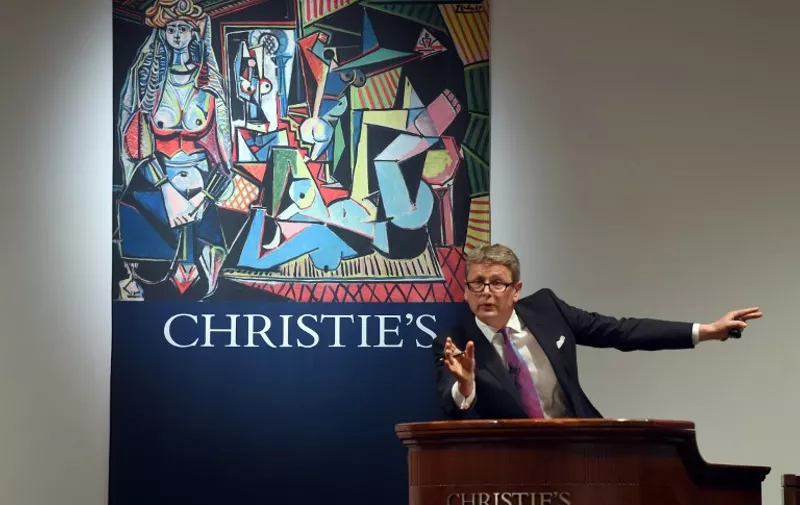 Auctioneer Jussi Pylkkanen takes bids on the Picasso masterpiece "Les Femmes d'Alger (Version O)" at Christie's in New York City on  May 11, 2015, which went for USD 179.3 million,  smashing the record for most expensive art sold at auction,  way over its pre-sale estimate of USD 140 million.   AFP PHOTO /  TIMOTHY  A. CLARY