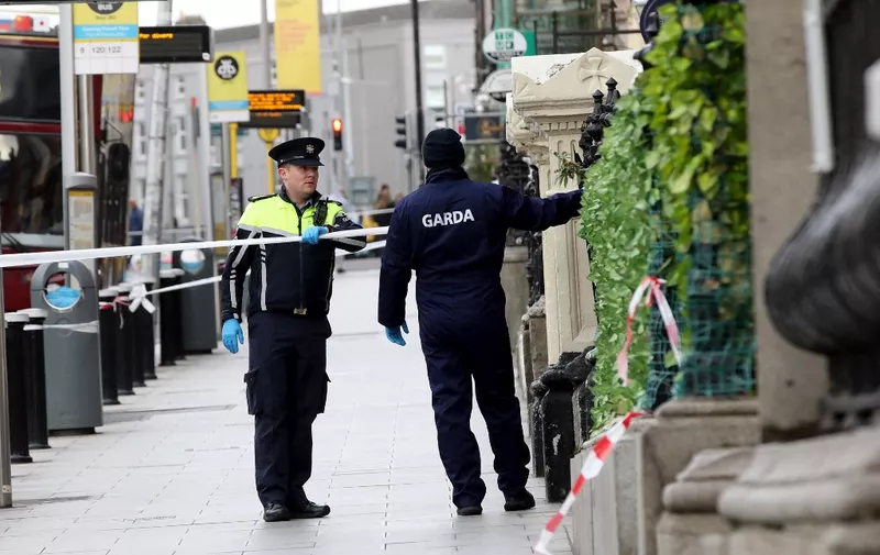 Irish Garda police officers stand on duty at the scene of the November 23 attack on Parnell Street, in Dublin on November 24, 2023. Violence that erupted in Dublin after three children were injured in a knife attack was of a level not  seen for decades, Ireland's police commissioner said on Friday. "What we saw last night was an extraordinary outbreak of violence," Garda Commissioner Drew Harris said. "These are scenes that we have not seen in decades." (Photo by PAUL FAITH / AFP)