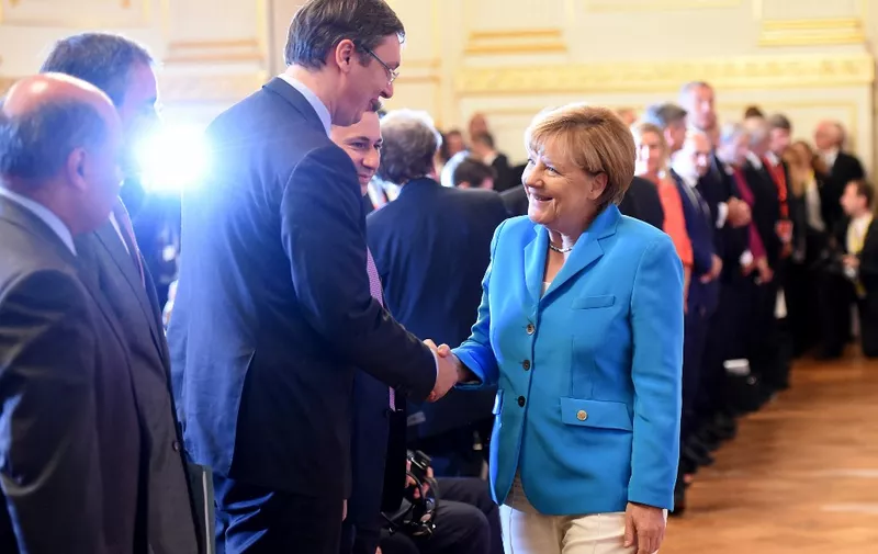 German Chancellor Angela Merkel (R) shakes hands with Serbian Prime Minister Alexander Vucic upon arrival for the Western Balkans Summit at the Hofburg palace in Vienna, Austria on August 27, 2015. German Chancellor Angela Merkel and Balkan leaders gathered in Vienna to seek how to tackle together the biggest migration crisis to hit Europe since World War II. AFP PHOTO / JOE KLAMAR (Photo by JOE KLAMAR / AFP)