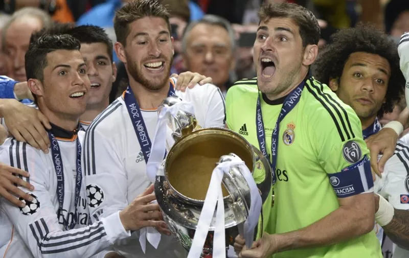 (FromL) Real Madrid's Portuguese forward Cristiano Ronaldo, Real Madrid's defender Sergio Ramos, Real Madrid's goalkeeper Iker Casillas and Real Madrid's Brazilian defender Marcelo teammates celebrate with the trophy at the end of the UEFA Champions League Final Real Madrid vs Atletico de Madrid at Luz stadium in Lisbon, on May 24, 2014. Real Madrid won 4-1.  AFP PHOTO/ FRANCK FIFE