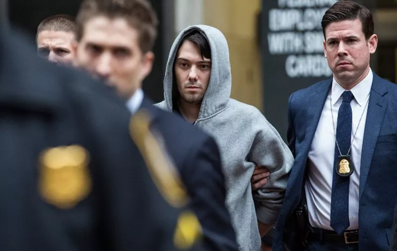 NEW YORK, NY - DECEMBER 17: Martin Shkreli (C), CEO of Turing Pharmaceutical, is brought out of 26 Federal Plaza by law enforcement officials after being arrested for securities fraud on December 17, 2015 in New York City. Shkreli gained notoriety earlier this year for raising the price of Daraprim, a medicine used to treat the parasitic condition of toxoplasmosis, from $13.50 to $750 though the arrest that happened early this morning does not involve that price hike.   Andrew Burton/Getty Images/AFP