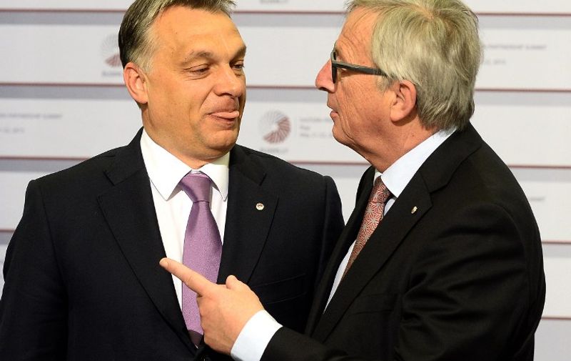 Hungarian Prime Minister Viktor Orban is greeted by President of the European Commission Jean-Claude Juncker on the second day of the fourth European Union (EU) eastern Partnership Summit in Riga, on May 22, 2015 as Latvia holds the rotating presidency of the EU Council. EU leaders and their counterparts from Ukraine and five ex-Soviet states hold a summit focused on bolstering their ties, an initiative that has been undermined by Russia's intervention in Ukraine. AFP PHOTO / JANEK SKARZYNSKI