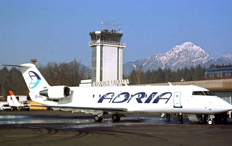 An aircraft of Slovenia's national air-carrier "Adria Airways" is parked at the airport of the capital Ljubljana, 17 January 2002. Slovenia, a former Yugoslav republic that declared independence in 1991, will join the European Union 01 May 2004 together with another nine central European countries, most of them formerly Communist. AFP PHOTO STRINGER (Photo by STRINGER / AFP)