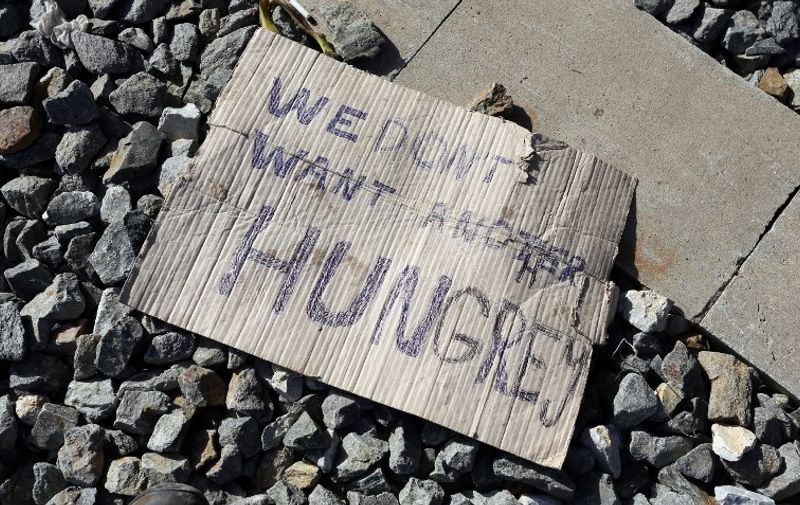 TOPSHOTS
A placard readin "We do not want another Hungary" lies on the ground at a railway station, near the official border crossing between  Croatia and Serbia, near the eastern-Croatian town of Tovarnik, on September 18 2015. Migrants have begun carving a new route into the Schengen area, travelling via Croatia, after neighbouring Hungary, overwhelmed by the refugee traffic, fenced off its own border with Serbia. For the moment, Croatia copes well with the influx of refugees, being still able to keep evidence of the people arriving and transporting them by train to refugee transit centers closer to nation's capital, Zagreb.  AFP PHOTO /STRINGER