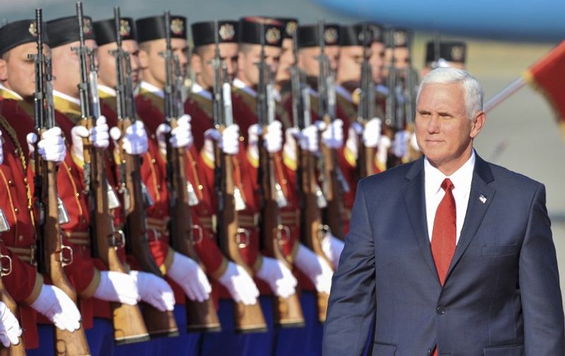 US Vice President Mike Pence reviews Montenegrin honor guards during a welcoming ceremony at Golubovci airport near Podgorica on August 1 2017, after Pence landed for the last leg of a tour of Eastern Europe.   
Pence is currently on a tour of Eastern Europe aimed at reassuring US allies rattled over Russia's 2014 annexation of Crimea and backing for a bloody separatist rebellion in Ukraine. After visiting Georgia, Pence headed to NATO's newest member Montenegro on the Adriatic Sea for the last leg of his trip. / AFP PHOTO / Savo PRELEVIC