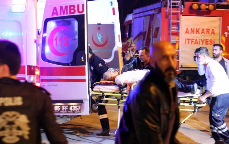 An injured person is loaded into an ambulance car following an explosion after an attack targeted a convoy of military service vehicles in Ankara on February 17, 2016.
At least five people were killed and 10 people were wounded in a car bombing in the Turkish capital Ankara on February 17, the city's governor said. The attack targeted a convoy of military service vehicles, Ankara governor Mehmet Kiliclar said, quoted by the CNN-Turk and NTV channels. / AFP / STR