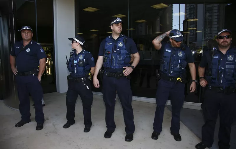 A police presence is seen outside the courthouse before the arrival of US actor Johnny Depp and his wife Amber Heard in the Gold Coast on April 18, 2016. Depp and his wife Amber Heard arrived at an Australian court April 18 over Heard's alleged illegal importation of their two Yorkshire terrier dogs Boo and Pistol into the country in a private jet in 2015, as Depp was in Australia for the filming of the latest Pirates of the Carribean movie. (Photo by Patrick HAMILTON / AFP)