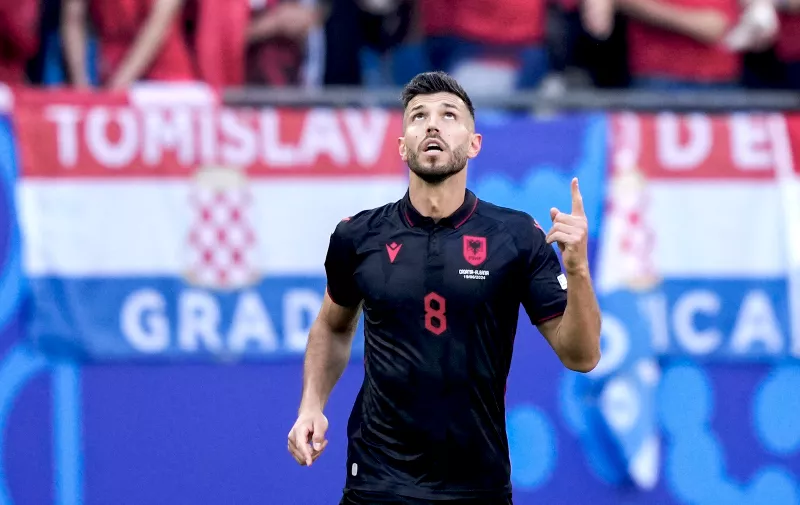 Albania's Klaus Gjasula celebrates after scoring his side's second goal during a Group B match between Croatia and Albania at the Euro 2024 soccer tournament in Hamburg, Germany, Wednesday, June 19, 2024. The match ended in a 2-2 draw. (AP Photo/Ebrahim Noroozi)