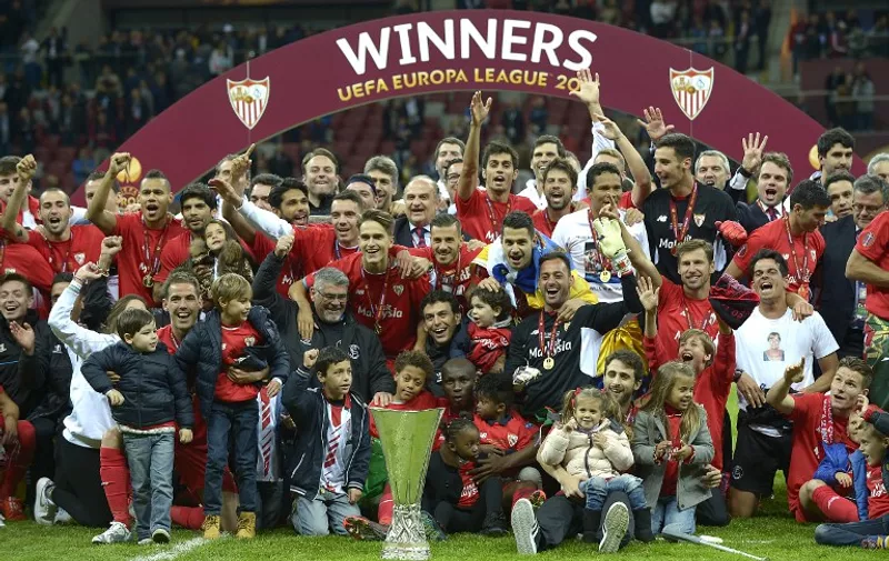 Sevilla's team celebrate with the trophy after the UEFA Europa League final football match between FC Dnipro Dnipropetrovsk and Sevilla FC at the Narodowy stadium in Warsaw, Poland on May 27, 2015. Sevilla FC won 2-3.   AFP PHOTO / JORGE GUERRERO