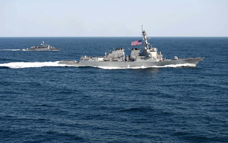 In this March 12, 2015 US Navy handout photo, the guided-missile detroyer USS Lassen (DDG 82) is underway in formation with the Republic of Korea patrol craft Sokcho (PCC 778) during exercise Foal Eagle 2015.  The United States defied China Tuesday by sending a warship close to artificial islands the rising Asian power is building in disputed waters, prompting Beijing to furiously denounce what it called a threat to its sovereignty.
The USS Lassen passed within 12 nautical miles -- the normal limit of territorial waters around natural land -- of at least one of the formations Beijing claims in the South China Sea. Chinese authorities "monitored, shadowed and warned" the guided missile destroyer in the Spratly islands, Beijing said. Washington's long-awaited move to assert freedom of navigation may escalate the dispute over the strategically vital waters, where Beijing has been transforming reefs and outcrops into artificial islands with potential military use. AFP PHOTO / HANDOUT / US NAVY / MC1 MARTIN WRIGHT     == RESTRICTED TO EDITORIAL USE / MANDATORY CREDIT: "AFP PHOTO / HANDOUT / US NAVY / MC1 MARTIN WRIGHT"/ NO MARKETING / NO ADVERTISING CAMPAIGNS / DISTRIBUTED AS A SERVICE TO CLIENTS ==