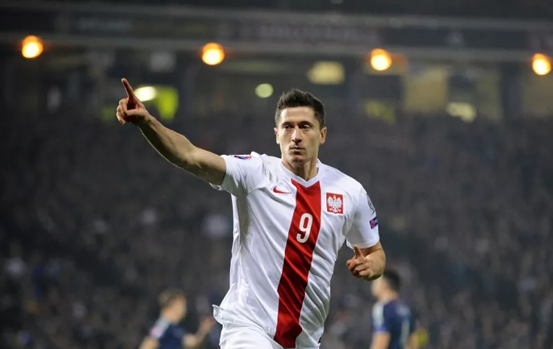 Poland's Robert Lewandowski celebrates after scoring the opening goal  during the UEFA Euro 2016 qualifying Group D football match between Scotland and Poland at Hampden Park in Glasgow, Scotland, on October 8, 2015.   AFP PHOTO / ANDY BUCHANAN