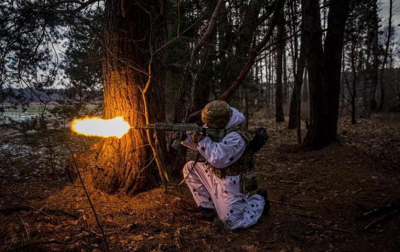 A Ukrainian serviceman fires during a joint military training of armed forces, national guards, border guards and Security Service of Ukraine in Rivne region, near the border with Belarus, on February 11, 2023, amid the Russian invasion of Ukraine. (Photo by Dimitar DILKOFF / AFP)