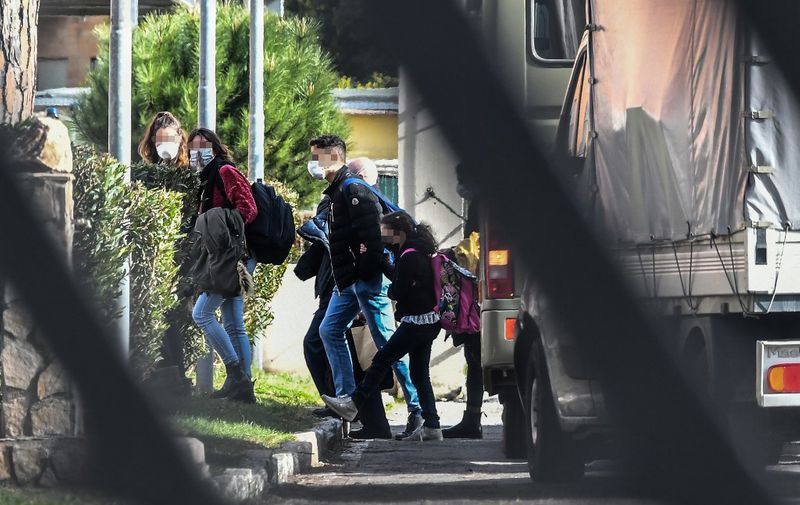 Italian citizens arrive at the Cecchignola quarantine center, south of Rome, on February 3, 2020 after being repatriated from the coronavirus hot-zone of Wuhan and landing at the nearby military airport of Pratica di Mare. (Photo by Tiziana FABI / AFP)