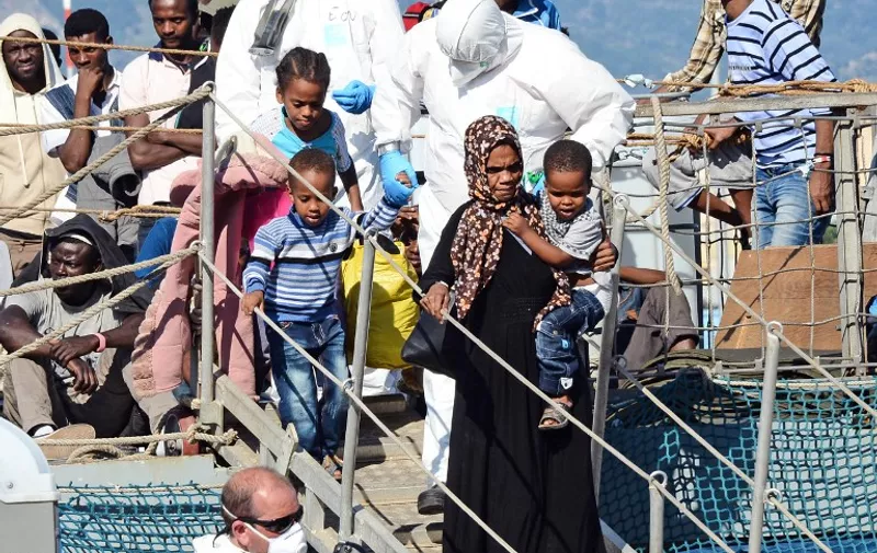 Migrants disembark from the Irish Navy ship upon their arrival in the port of Messina on the coast of Sicily on June 23, 2015. Italy's wealthy North vowed that it would refuse to accommodate any more migrants as thousands more were rescued in the Mediterranean by a multinational flotilla of ships.
 PH. CONTROLUCE/GIOVANNI ISOLINO