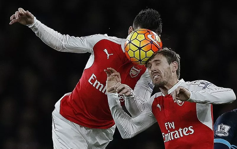 Arsenal's French defender Laurent Koscielny (L) and Arsenal's Spanish defender Nacho Monreal head the same ball during the English Premier League football match between Arsenal and Manchester City at the Emirates Stadium in London on December 21, 2015. AFP PHOTO / ADRIAN DENNIS 

RESTRICTED TO EDITORIAL USE. No use with unauthorized audio, video, data, fixture lists, club/league logos or 'live' services. Online in-match use limited to 75 images, no video emulation. No use in betting, games or single club/league/player publications. / AFP / ADRIAN DENNIS