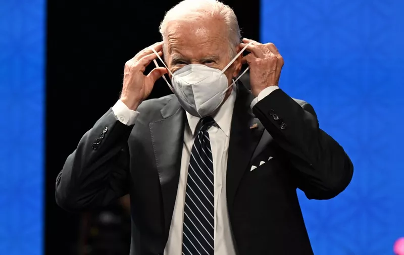 US President Joe Biden adjusts his mask as he attends the Indo-Pacific Economic Framework for Prosperity at the Izumi Garden Gallery in Tokyo on May 23, 2022. (Photo by SAUL LOEB / AFP)