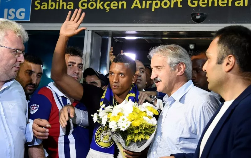 Manchester Uniteds former Portuguese midfielder Luis Nani (C) gestures as he arrives at the Sabiha Gokcen airport on July 5 2015 in Istanbul. Nani will sign a new contract on July 6 with Istanbul's Fenerbahce Football Club. AFP PHOTO/ OZAN KOSE