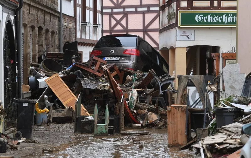 Debris and a damaged car pile up in a street in Bad Neuenahr-Ahrweiler, western Germany, on July 16, 2021, after heavy rain hit parts of the country, causing widespread flooding and major damage. - The death toll from devastating floods in Europe soared to at least 126 on July 16, most in western Germany where emergency responders were frantically searching for missing people. (Photo by Christof STACHE / AFP)