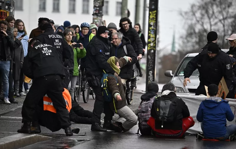 Police removes activists during a "disobedient assembly" called by environmental movement "Letzte Generation" In Berlin, on March 16, 2024. (Photo by Tobias SCHWARZ / AFP)