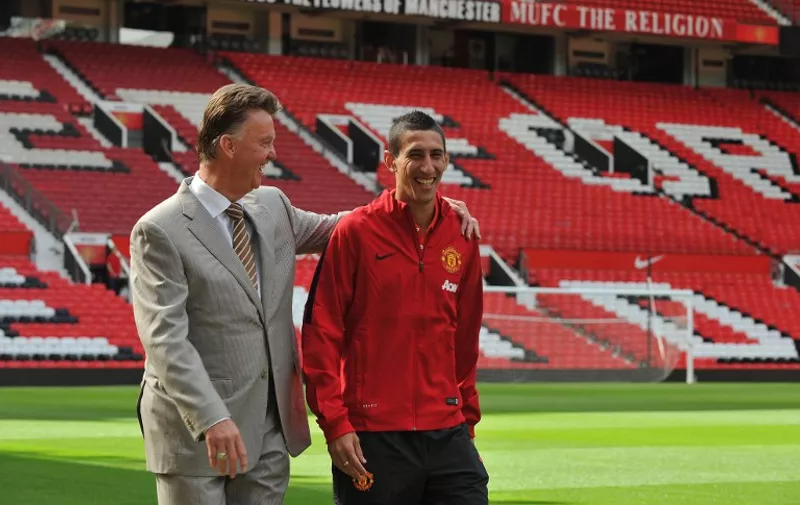 Manchester United's Dutch manager Louis van Gaal (L) walks with Manchester United's newly-signed Argentinian midfielder Angel di Maria (R) during an official presentation on the pitch at Old Trafford in Manchester, north-west England on August 28, 2014. Manchester United announced on August 26, 2014 that they have signed Argentina winger Angel di Maria from Real Madrid for a British-record transfer fee of 59.7 million GBP (98 million USD, 75 million euros).  AFP PHOTO / STEVE PARKIN  --  RESTRICTED TO EDITORIAL USE. No use with unauthorized audio, video, data, fixture lists, club/league logos or live services. Online in-match use limited to 45 images, no video emulation. No use in betting, games or single club/league/player publications.