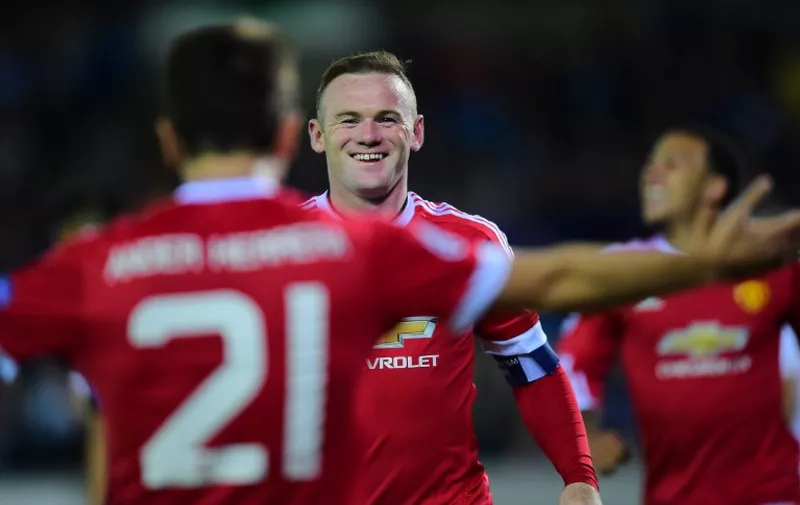 Manchester United's Wayne Rooney celebrates after scoring his second goal during the UEFA Champions League playoff football match between Club Brugge and Manchester United at Jan Breydel Stadium in Bruges, on August 26, 2015. AFP PHOTO/Emmanuel Dunand