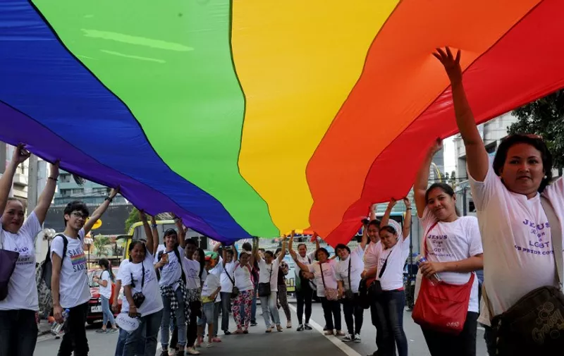 Filipino members and supporters of the LGBT community take part in an annual gay pride march calling for equal rights for lesbian, gay, bisexual and transgender (LGBT) people in suburban Manila on December 5, 2015. The Philippines made headlines when it held the first gay pride march in Asia in 1994 and a few years ago became the first country in Southeast Asia to have an official gay political party.  AFP PHOTO / Jay DIRECTO / AFP / JAY DIRECTO