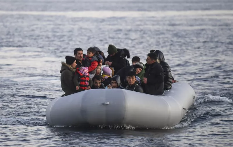 Refugees and migrants aboard an inflatable boat arrive in the Greek island of Lesbos on March 2, 2020. - Around 500 migrants landed on Sunday morning in around 10 vessels, according to an AFP tally, their crossing made easier by the good weather conditions. Another four vessels carrying 120 people landed on the neighbouring island of Chios, and two vessels carrying 80 migrants landed on Samos, further to the south, ANA reported. According to the Greek coastguard, around 180 migrants arrived Saturday on Lesbos and Samos, making the crossing from Turkey despite strong winds. (Photo by ARIS MESSINIS / AFP)