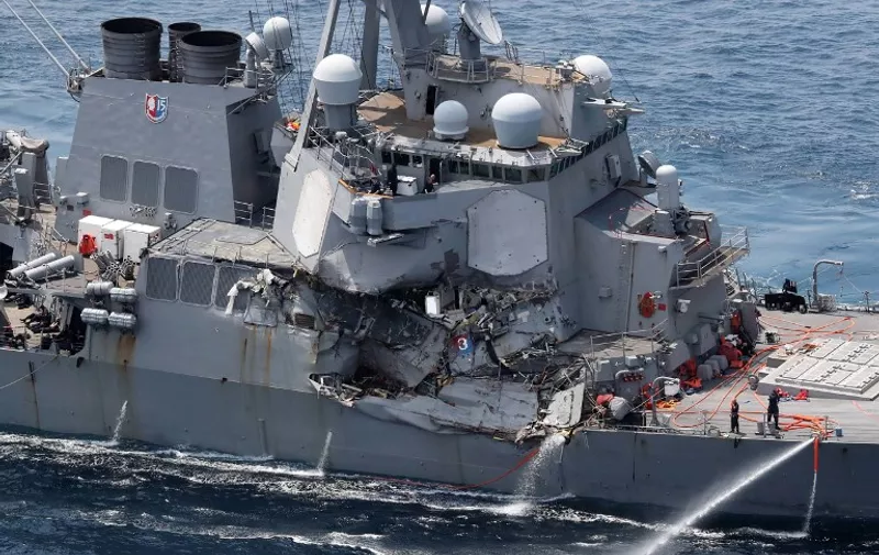 Damage is seen on the guided missile destroyer USS Fitzgerald off the Shimoda coast, after it collided with a Philippine-flagged container ship, on June 17, 2017.
Seven US sailors were missing and a skipper injured after their Navy destroyer collided with a container ship off the coast of Japan early on June 17, with the badly damaged US vessel partially flooded. / AFP PHOTO / JIJI PRESS / STR / Japan OUT