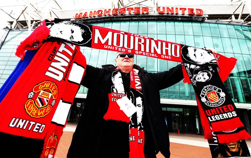 Scarf seller holds up a Jose Mourinho scarf outside Old Trafford, Manchester. ***Editors note name badge pixelated by picture desk***., Image: 287111770, License: Rights-managed, Restrictions: WCDIRECT, Model Release: no, Credit line: Profimedia, Press Association